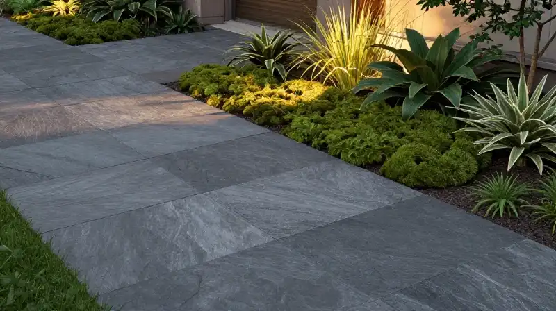 A lush courtyard of textured slate pavers bathed in golden hour light