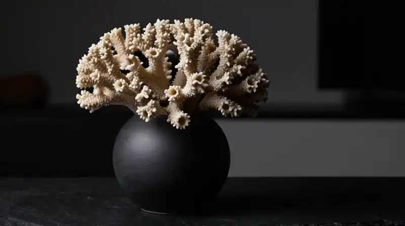 Obsidian bells stand in a vase on a sleek black surface