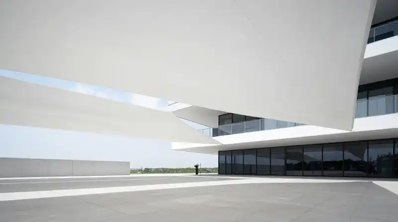 White sculptural shade sails define a stark, modern minimalist terrace